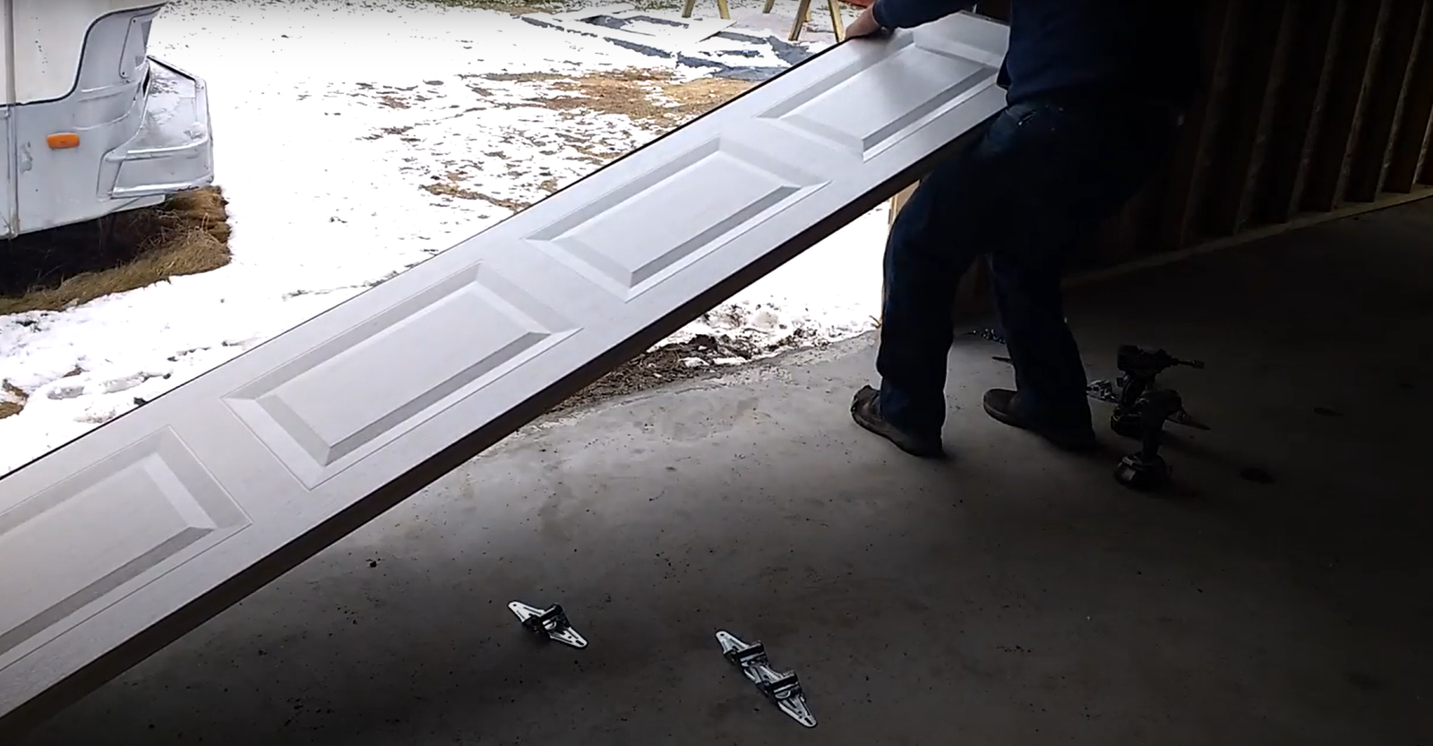 Damaged garage door panel being professionally repaired to enhance functionality and aesthetics for a home in Laurel, Florida.
