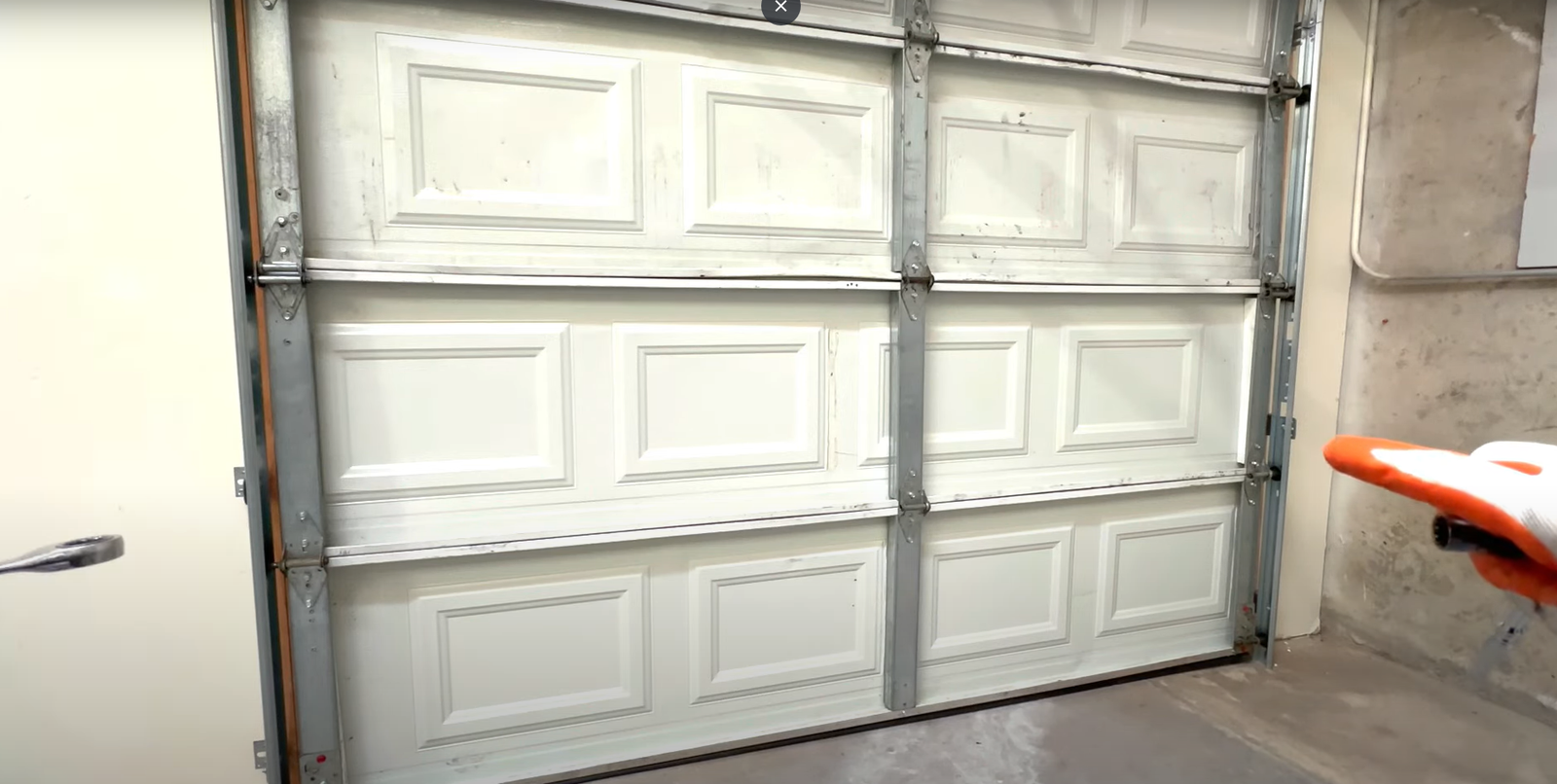 A professional technician from Garage Door Repair Services Laurel Florida LLC repairing a garage door track to ensure smooth and safe operation.