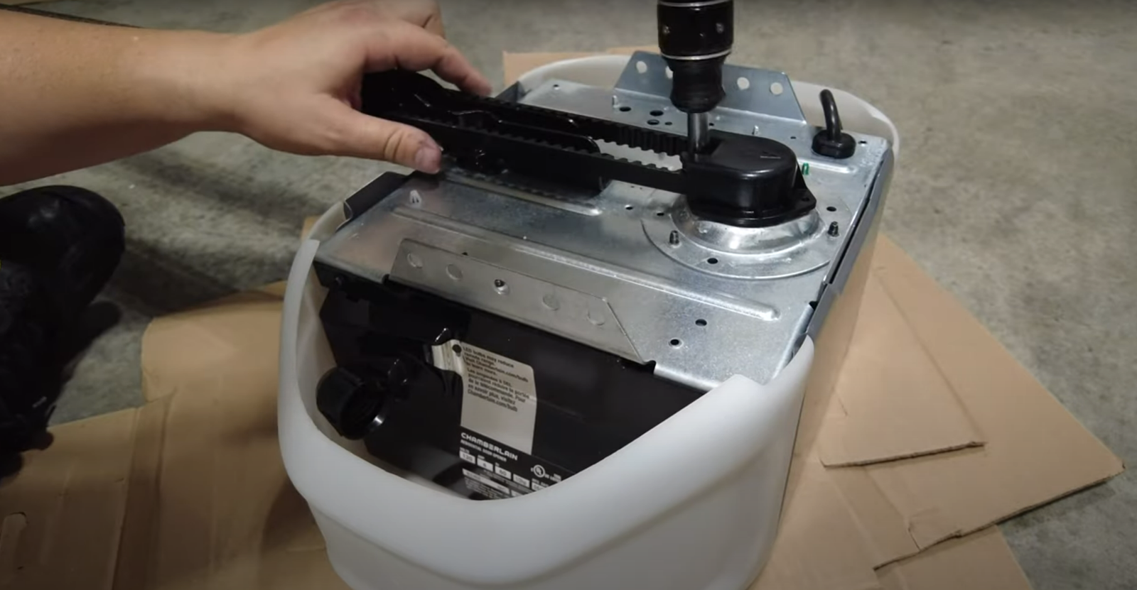 Professional technician from Garage Door Repair Services Laurel Florida LLC inspecting a garage door opener system during routine maintenance to prevent costly repairs.