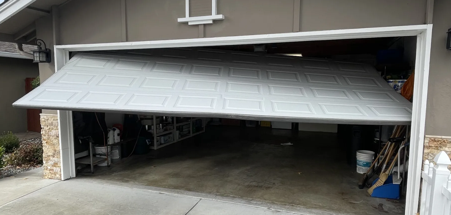 Garage door damaged by improper DIY repair attempts