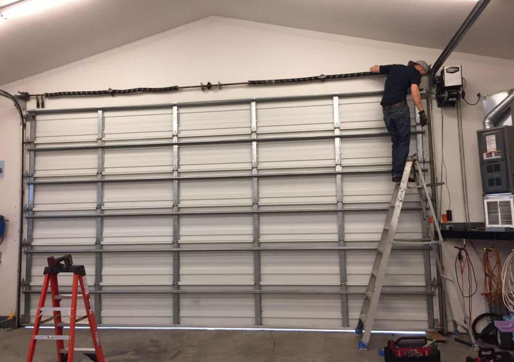 Lightweight residential garage door tracking unsuited for commercial building applications