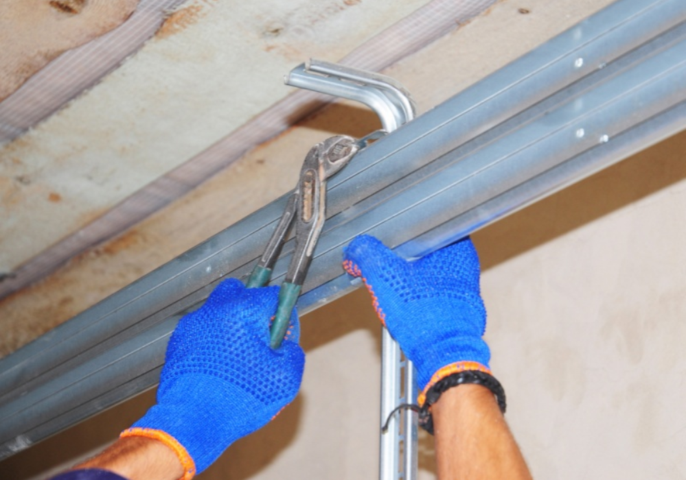 Professional garage door technician aligning heavy duty track rails in Gulf Gate Estates